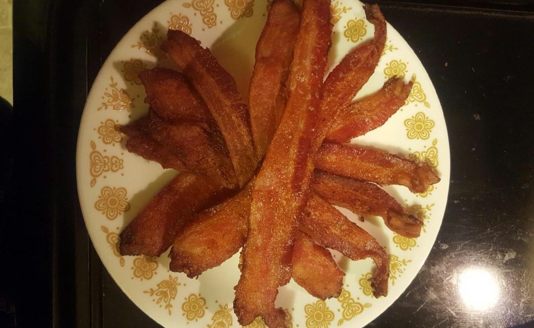 Perfectly cooked bacon on a tray.